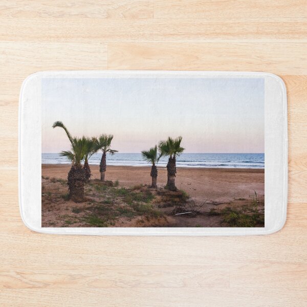 Item preview, Tranquil Beach With Palm Trees Along Sandy Shoreline at Pastel Sunrise Over Calm Sea designed and sold by Nmallia.