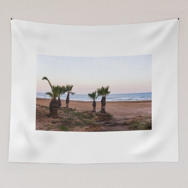 Item preview, Tranquil Beach With Palm Trees Along Sandy Shoreline at Pastel Sunrise Over Calm Sea designed and sold by Nmallia.