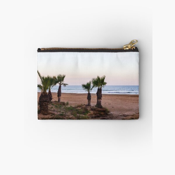 Item preview, Tranquil Beach With Palm Trees Along Sandy Shoreline at Pastel Sunrise Over Calm Sea designed and sold by Nmallia.