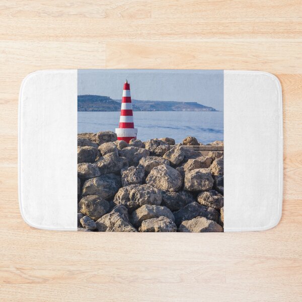 Item preview, Red and White Striped Lighthouse on Rocky Breakwater by Calm Sea with Distant Coastline designed and sold by Nmallia.