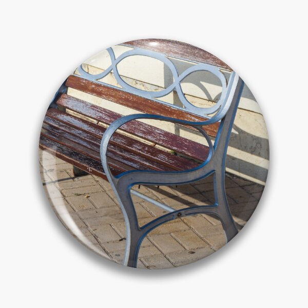 Item preview, Wooden And Metal Park Bench Casting Shadow Along Flowerbed On Sunny Pavement designed and sold by Nmallia.