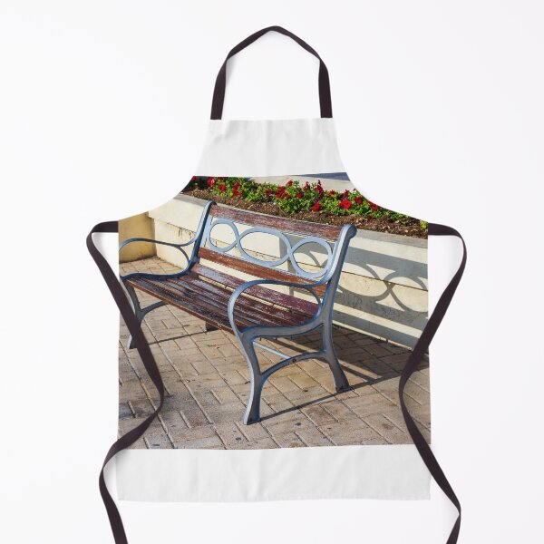 Item preview, Wooden And Metal Park Bench Casting Shadow Along Flowerbed On Sunny Pavement designed and sold by Nmallia.