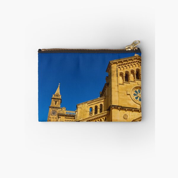 Item preview, Historic Stone Cathedral Facade With Clock Tower And Rose Window Against A Clear Blue Sky designed and sold by Nmallia.