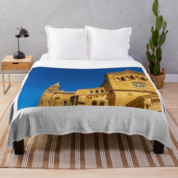 Item preview, Historic Stone Cathedral Facade With Clock Tower And Rose Window Against A Clear Blue Sky designed and sold by Nmallia.