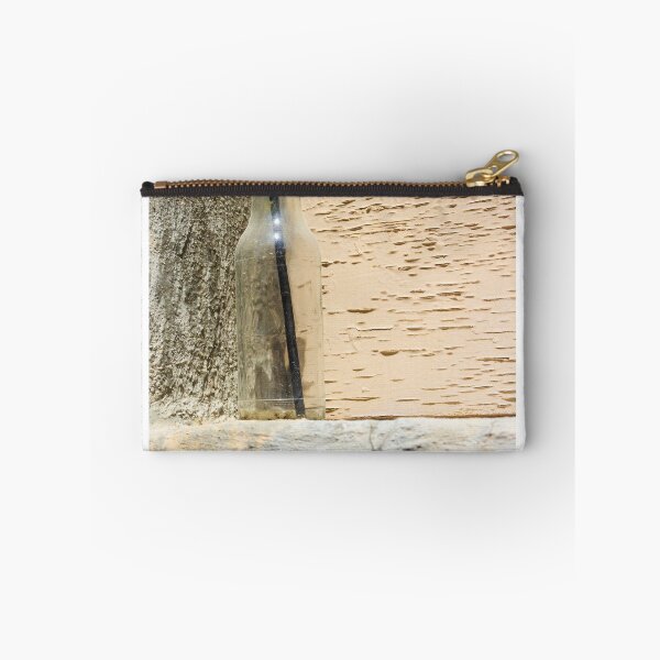 Item preview, Glass Bottle With Black Straw Against Textured Painted Wall On Concrete Ledge designed and sold by Nmallia.