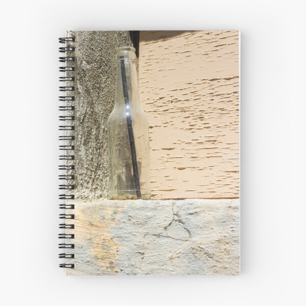 Item preview, Glass Bottle With Black Straw Against Textured Painted Wall On Concrete Ledge designed and sold by Nmallia.