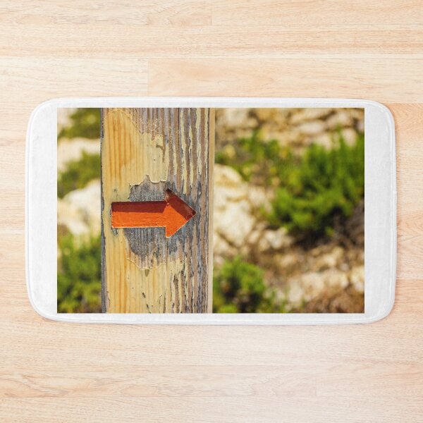 Item preview, Weathered Wooden Post With Orange Arrow Direction Sign Pointing Right On Outdoor Trail designed and sold by Nmallia.