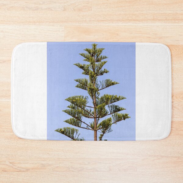 Item preview, Tall Pine Tree Top Against Clear Blue Sky With Layered Branches And Green Needles designed and sold by Nmallia.