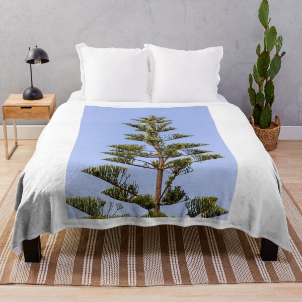 Item preview, Tall Pine Tree Top Against Clear Blue Sky With Layered Branches And Green Needles designed and sold by Nmallia.