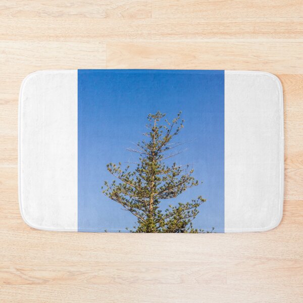 Item preview, Tall Pine Tree Top Against Clear Blue Sky With Layered Branches And Green Needles designed and sold by Nmallia.