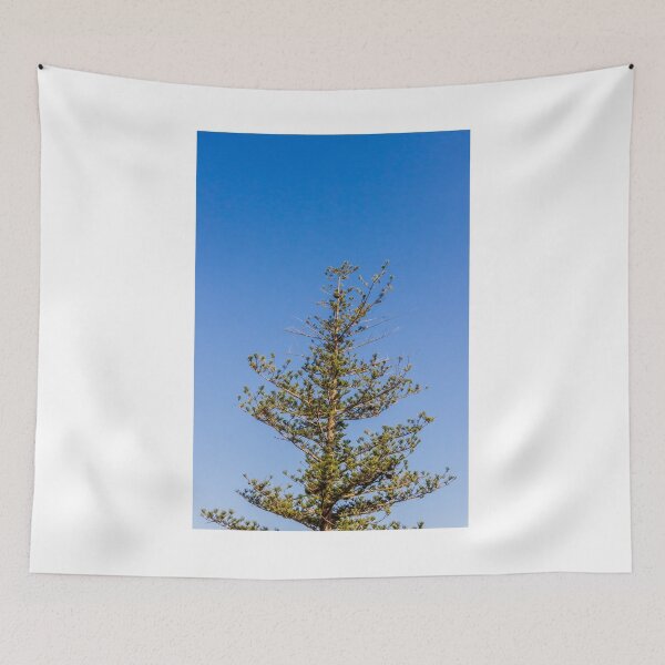 Item preview, Tall Pine Tree Top Against Clear Blue Sky With Layered Branches And Green Needles designed and sold by Nmallia.