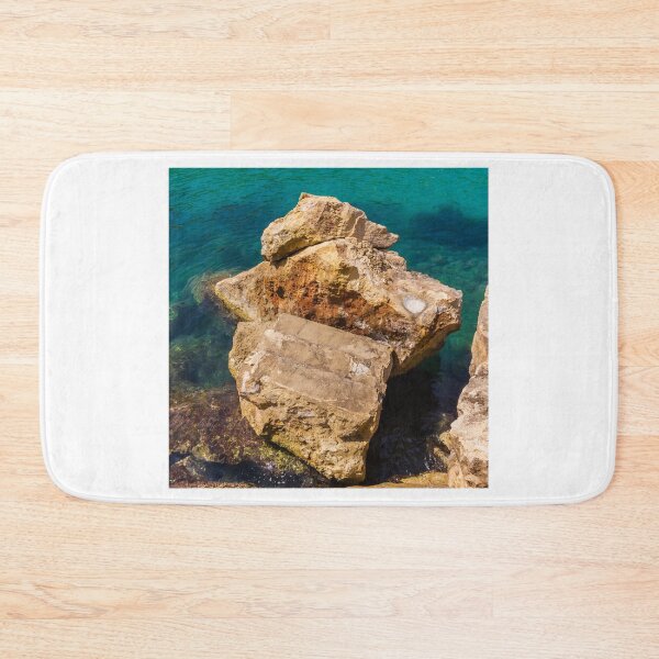 Item preview, Turquoise Sea Water and Sunlit Coastal Rocks on a Rocky Cliff by the Shoreline designed and sold by Nmallia.
