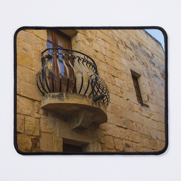 Item preview, Old Stone Building With Wrought Iron Balcony And Wooden Window On Sunny Day designed and sold by Nmallia.