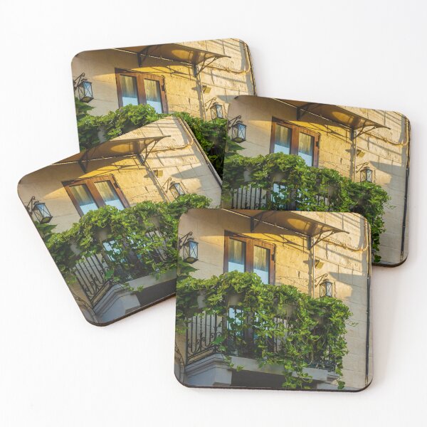 Item preview, Sunlit Balcony With Lush Green Vines Draping Over Iron Railing And Wooden Doors designed and sold by Nmallia.