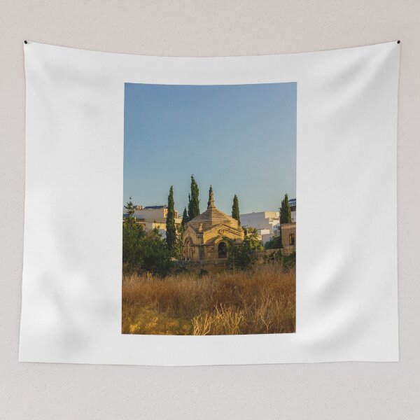 Item preview, Historic Stone Mausoleum Chapel With Cross Among Cypress Trees Overlooking Urban Landscape At Golden Hour designed and sold by Nmallia.
