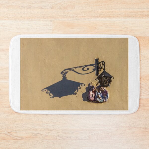 Item preview, Ceramic Nativity Plaque With Metal Lantern Casting Dramatic Shadow On Sunlit Yellow Wall designed and sold by Nmallia.