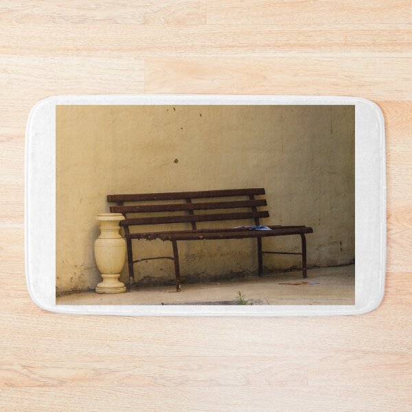 Item preview, Empty Rustic Bench Against a Weathered Wall in a Quiet Urban Corner designed and sold by Nmallia.