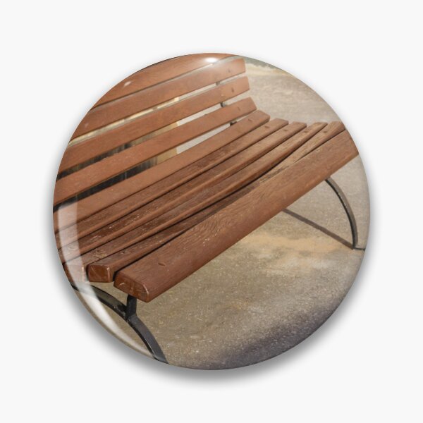Item preview, Empty Wooden Bench in Sunlit Urban Park Beside Stone Wall on Asphalt Walkway Outdoor Seating designed and sold by Nmallia.