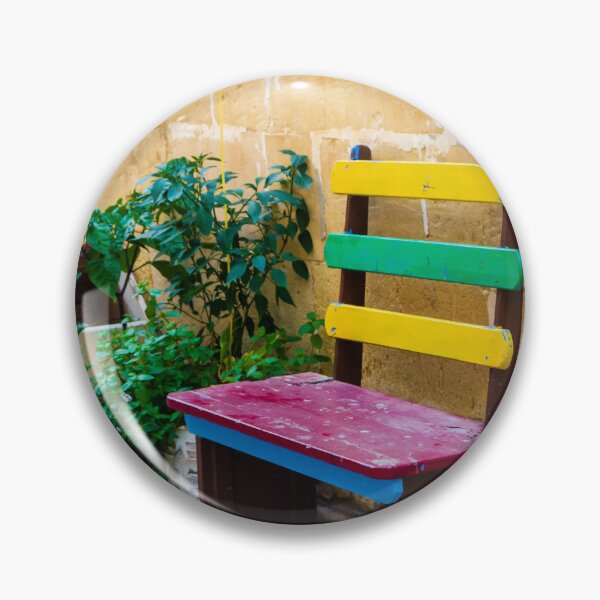 Item preview, Colorful Wooden Bench Against Textured Yellow Wall in Sunny Courtyard With Green Plants designed and sold by Nmallia.