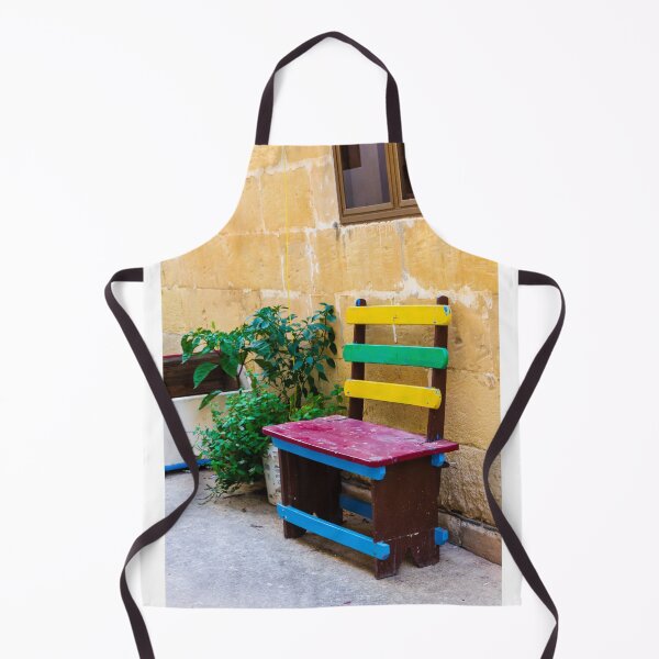 Item preview, Colorful Wooden Bench Against Textured Yellow Wall in Sunny Courtyard With Green Plants designed and sold by Nmallia.