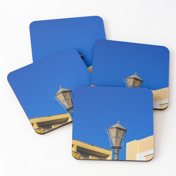 Item preview, Rustic Street Lamp Against a Bright Blue Sky and Modern Architecture designed and sold by Nmallia.