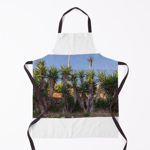 Item preview, Tropical Yucca Plants Growing Along a Hillside Under a Clear Blue Sky designed and sold by Nmallia.