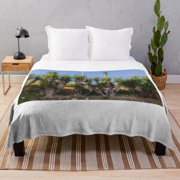 Item preview, Tropical Yucca Plants Growing Along a Hillside Under a Clear Blue Sky designed and sold by Nmallia.