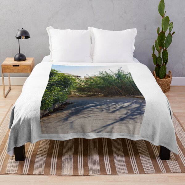 Item preview, Serene Outdoor Scene with Green Foliage and Shadows on Concrete Pathway designed and sold by Nmallia.