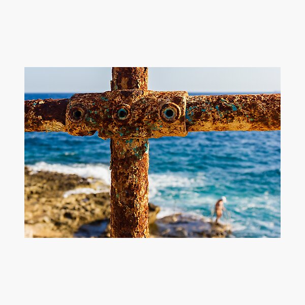 Item preview, Rusty Metal Rail with Ocean Background and Person on Rocky Shore designed and sold by Nmallia.