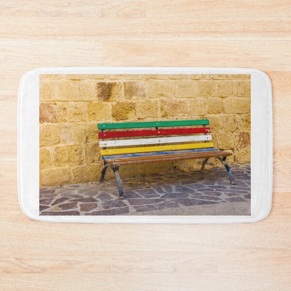 Item preview, Colorful Painted Bench Against Rustic Stone Wall On Sunny Mediterranean Street designed and sold by Nmallia.