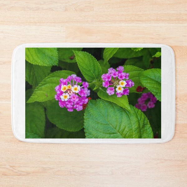 Item preview, Vibrant Pink and Yellow Flowers Among Green Leaves in a Natural Setting designed and sold by Nmallia.