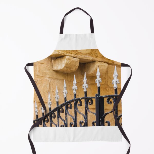 Item preview, Ornate Wrought Iron Fence With White Finials Against Warm Sandstone Wall In Historic Setting designed and sold by Nmallia.