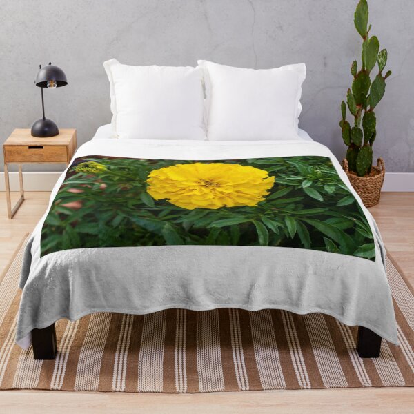 Item preview, Bright Yellow Marigold Flower Surrounded by Green Leaves in a Garden Setting designed and sold by Nmallia.