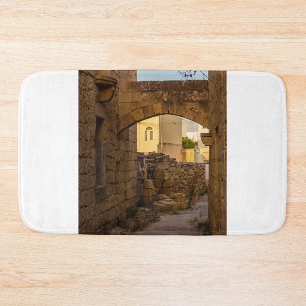 Item preview, Stone Alley Arch In Historic Old Town Alleyway With Sunlit Stone Walls And Quiet Path designed and sold by Nmallia.