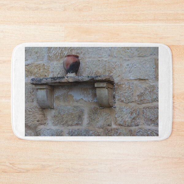 Item preview, Earthenware Jug On Stone Shelf Against Weathered Sandstone Wall In Mediterranean Village designed and sold by Nmallia.