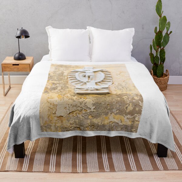 Item preview, White Crucifix Relief With Skull Sculpture On Weathered Yellow Wall Symbolizing Faith And Mortality designed and sold by Nmallia.