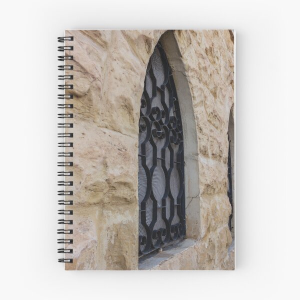 Item preview, Rustic Stone Wall With Arched Window And Decorative Iron Bars On Exterior Building designed and sold by Nmallia.