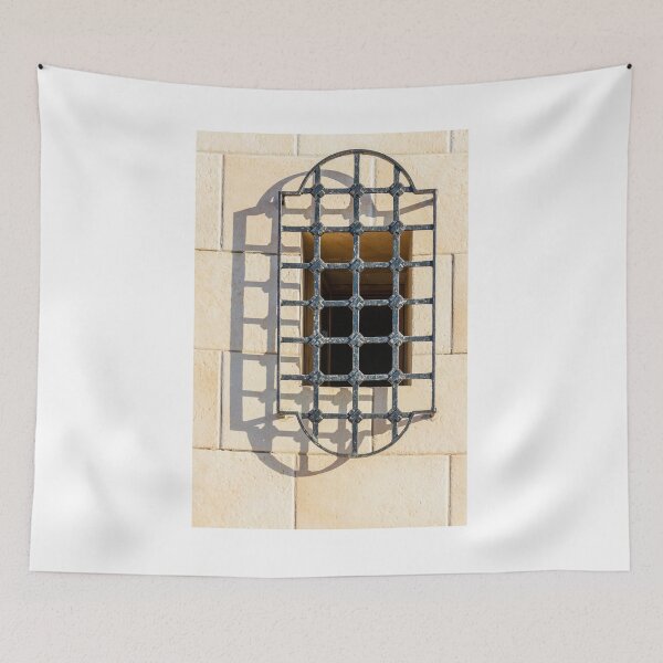 Item preview, Intricate Iron Window Grille Over Beige Stone Wall Casting Long Shadow in Warm Sunlight designed and sold by Nmallia.
