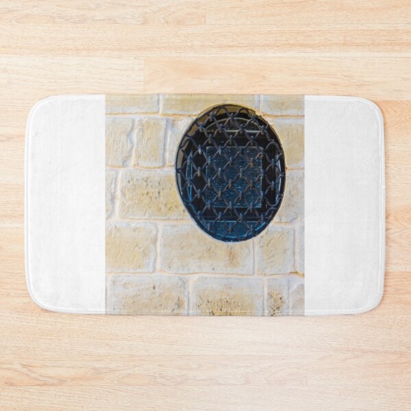 Item preview, Circular Metal Grate Over Window in Beige Stone Wall Creates Historic, Industrial Detail designed and sold by Nmallia.