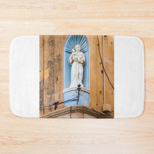 Item preview, White Saint Statue Holding Child in Blue Niche on Weathered Church Facade, Religious Architectural Detail designed and sold by Nmallia.