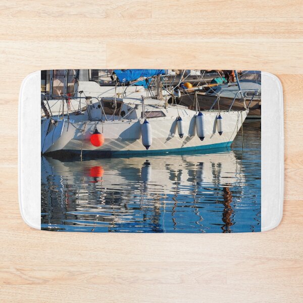 Item preview, Small Sailboat with Colourful Reflections Anchored in Calm Harbour Waters designed and sold by Dorset Girl.