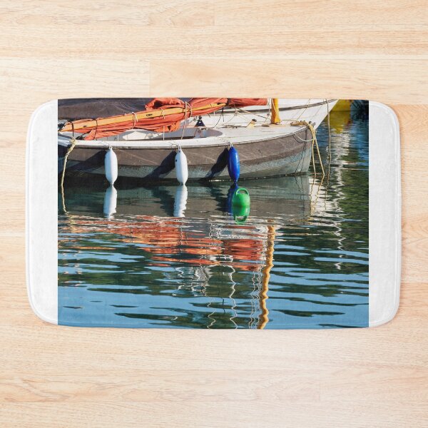 Item preview, Small Sailboat with Colourful Reflections Anchored in Calm Harbour Waters designed and sold by Dorset Girl.