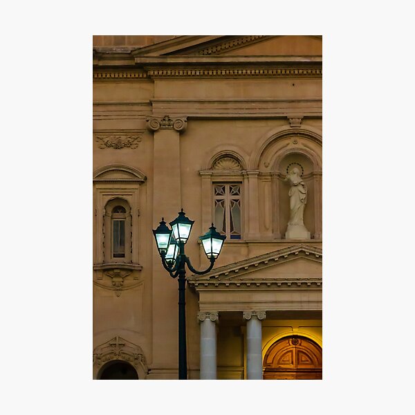 Item preview, Glowing Street Lamp in Front of Historic Classical Building With Statue and Columns at Night designed and sold by Nmallia.
