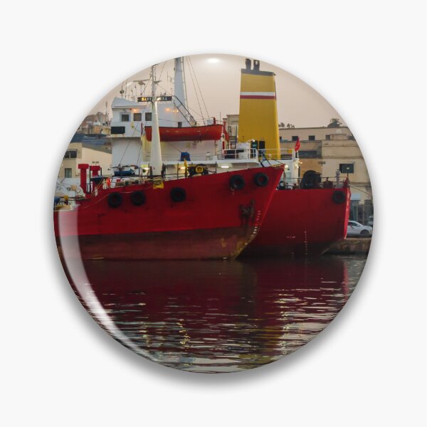 Item preview, Red Cargo Ship Docked at Industrial Harbor With Evening Reflections on Calm Water designed and sold by Nmallia.