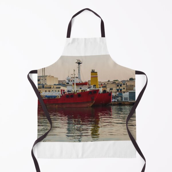 Item preview, Red Cargo Ship Docked at Industrial Harbor With Evening Reflections on Calm Water designed and sold by Nmallia.