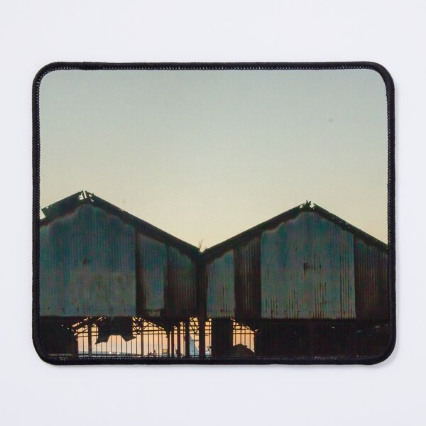 Item preview, Silhouetted Rusted Warehouse Sheds Along Waterfront At Sunset With Dusk Sky and Pier Structures designed and sold by Nmallia.