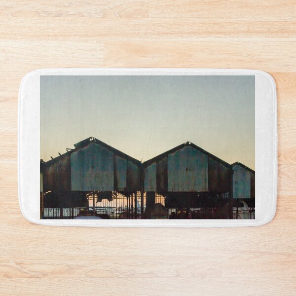 Item preview, Silhouetted Rusted Warehouse Sheds Along Waterfront At Sunset With Dusk Sky and Pier Structures designed and sold by Nmallia.