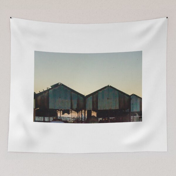 Item preview, Silhouetted Rusted Warehouse Sheds Along Waterfront At Sunset With Dusk Sky and Pier Structures designed and sold by Nmallia.