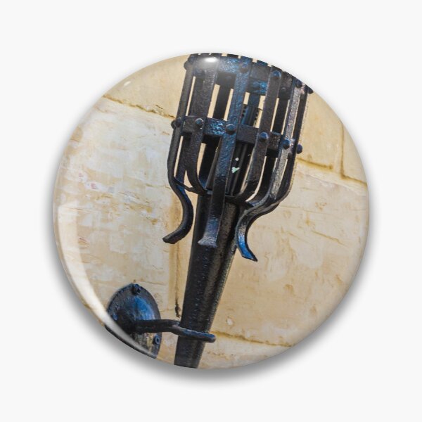 Item preview, Antique Black Iron Wall Torch with Spiked Holder Mounted on Rustic Stone Wall designed and sold by Nmallia.