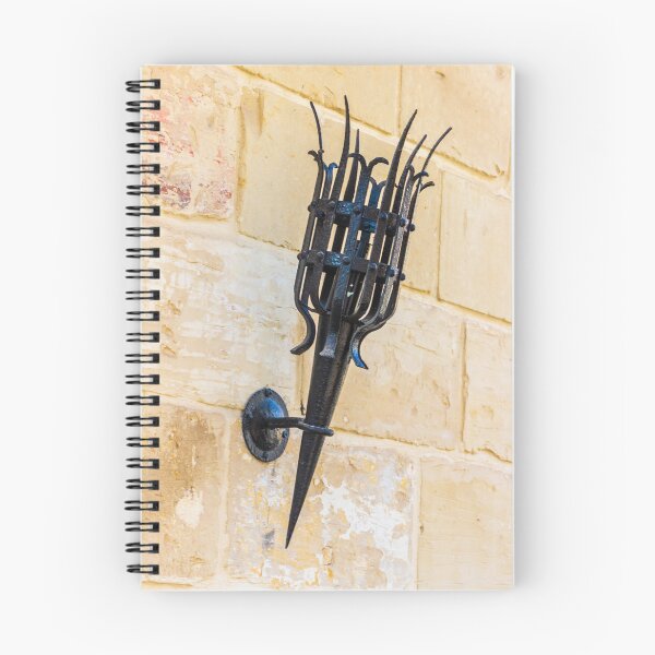 Item preview, Antique Black Iron Wall Torch with Spiked Holder Mounted on Rustic Stone Wall designed and sold by Nmallia.
